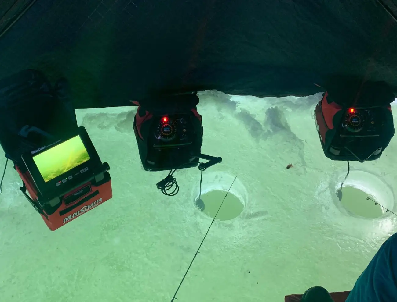 Ice fishing setup with sonar and drilled holes during a guided trip in Northern Wisconsin